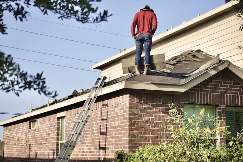 Professional roofer working on a residential roof in Maize-Morse